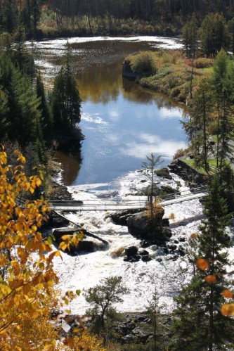 Aerial view of a walking bridge over rapids